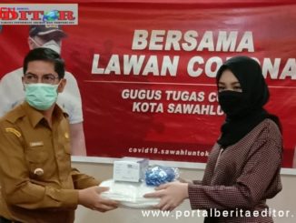 Athari Gauti Ardi saat menyerahkan bantuan APD kepada Walikota Sawahlunto Deri Asta.