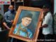 Muharyadi didampingi Zardi Syahrir dan Ucok saat menyerahkan lukisa potret H. M. Nurnas.
