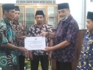 Zarfi Deson saat menyerahkan bantuan.