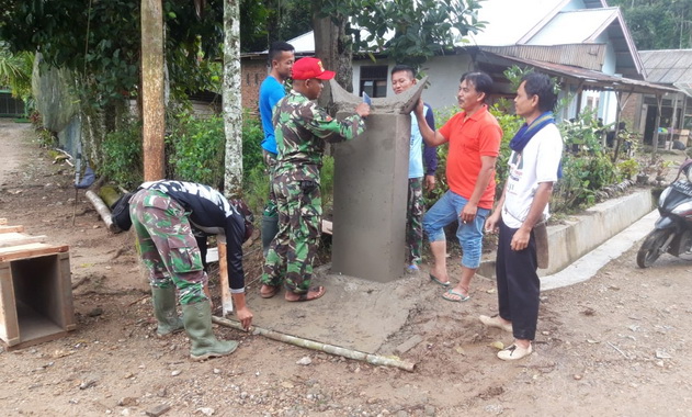 Goro personil satgas TMMD bersama masarakat membuat tugu TMMDN.