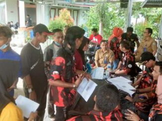 Anggota Pemuda Pancasila Padang Pariaman antri mengisi formulir untuk vaksinasi Covid-19.