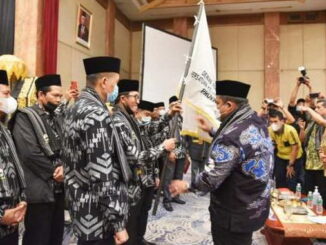 Bupati Padang Pariaman Suhatri Bur menyerahkan pataka kepada Ketua DPW PKDP Provinsi Riau Periode 2021-2026.