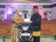 Fauzi Bahar saat memberikan hadiah sepeda motor secara simbolis.