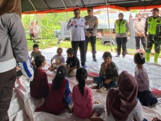 Kapolres Tanah Datar AKBP Derry Indra bersama Bupati Eka Putra ikut bermain dan bercengkarama dengan anak-anak di pengungsian.