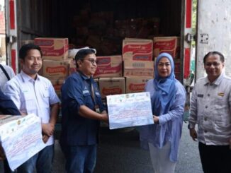 Kepala Dinas Komonfo Tanah Datar saat menerima bantuan.