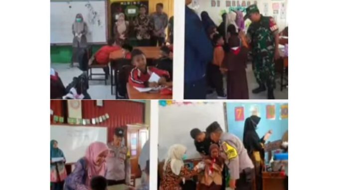 Petugas kesehatan memberikan imunisasi campak kepada anak di SDIT Al Ishlah Bukittinggi dalam kegiatan Outbreak Response Immunization (ORI) Campak.